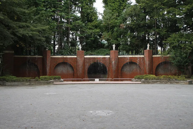 The brick wall with statues and the open plaza in Kibogaoka Park.