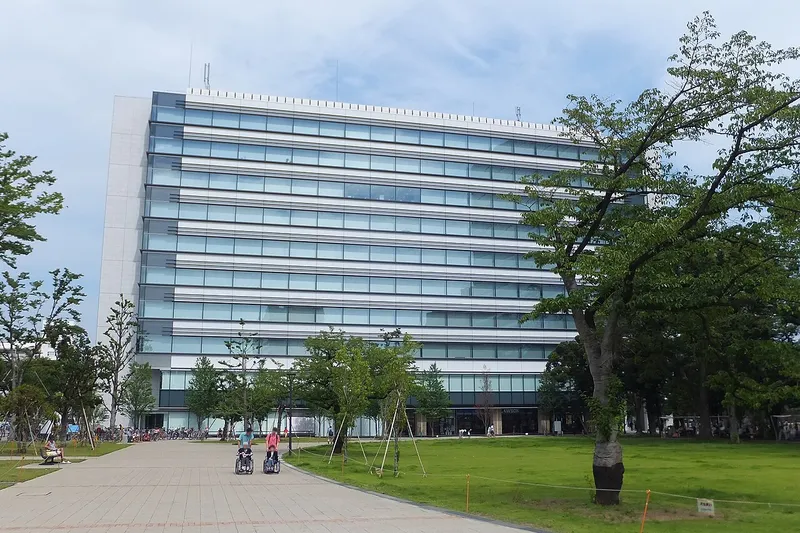 The East Building of Nakano Central Park with its lawn and walkway.